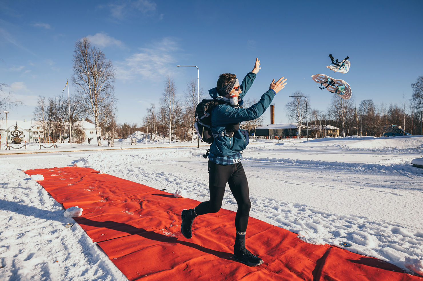 throwing my snowshoes away at the finish line of the beyond the ultimate ice ultra marathon
