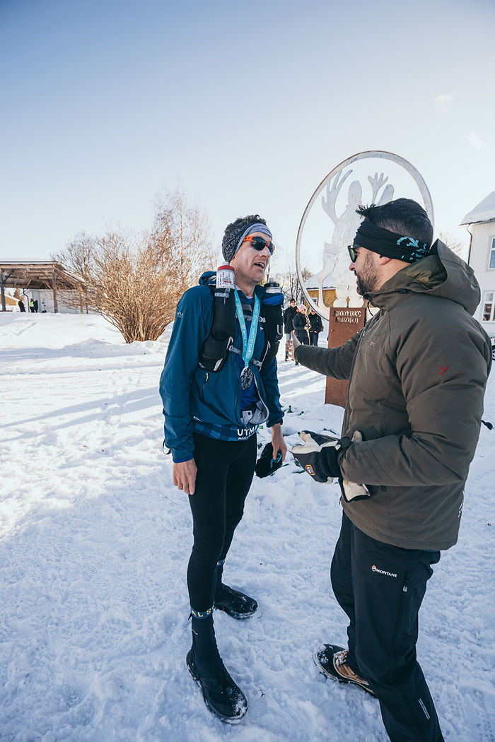 runner receives a medal at the end of the beyond the ultimate ice ultra